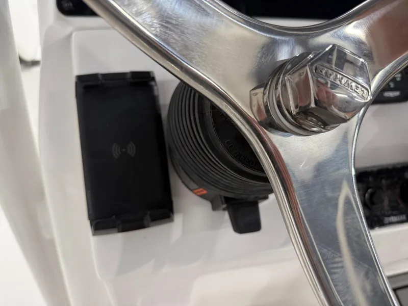Slide: The Image of Close-up of 2025 Tidewater 210LXF boat steering wheel and control panel. - 23