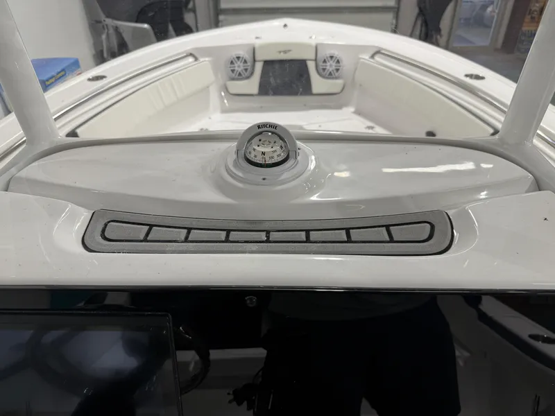Slide: The Image of 2025 Tidewater 210LXF boat dashboard with compass and control panel. - 27