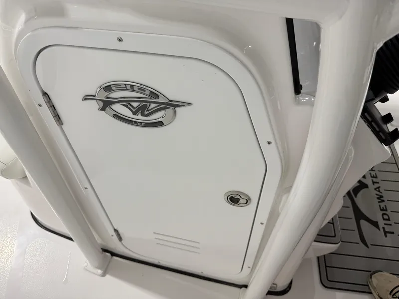 Slide: The Image of 2025 Tidewater 210LXF boat interior with logo and storage compartment. - 30