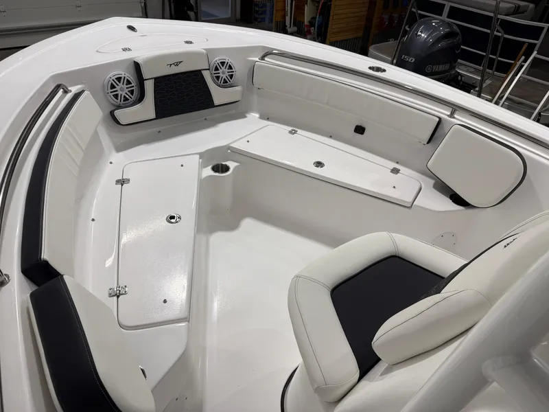 Slide: The Image of 2025 Tidewater 210LXF boat interior with white seating and Yamaha engine. - 31