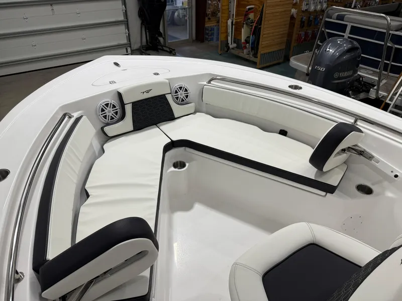 Slide: The Image of 2025 Tidewater 210LXF boat interior with white seating and speakers. - 43