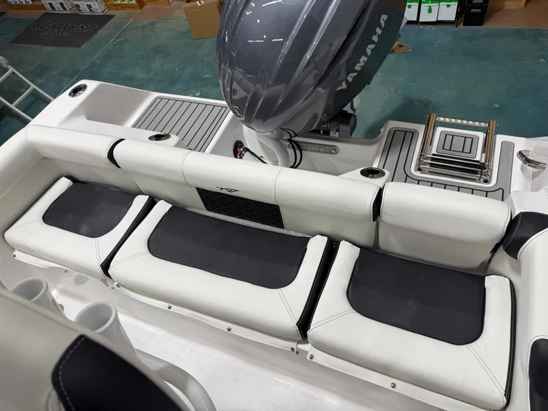 Slide: The Image of 2025 Tidewater 210LXF boat interior with Yamaha engine and cushioned seating. - 44