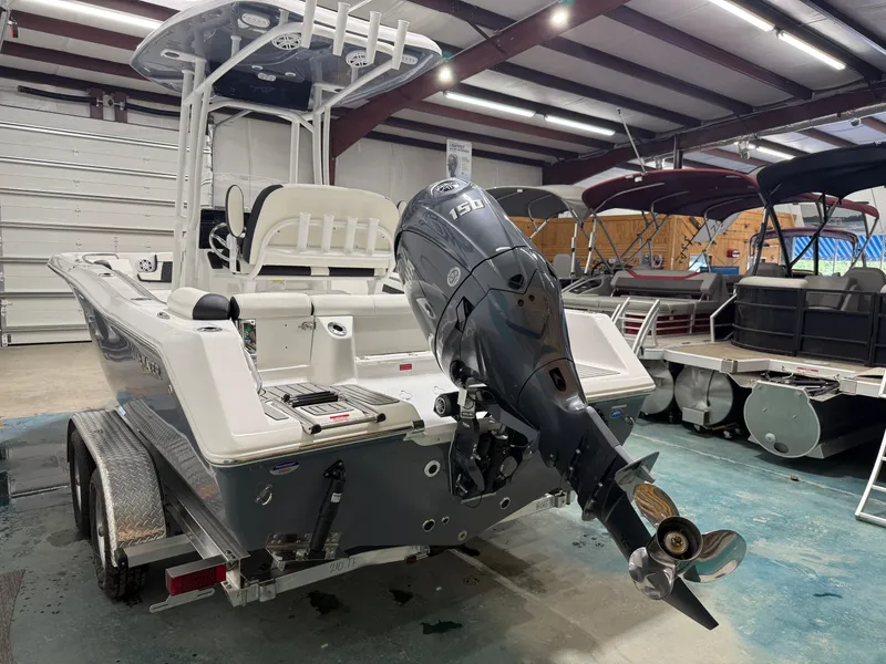 Slide: The Image of 2025 Tidewater 210LXF boat with outboard motor in showroom. - 6