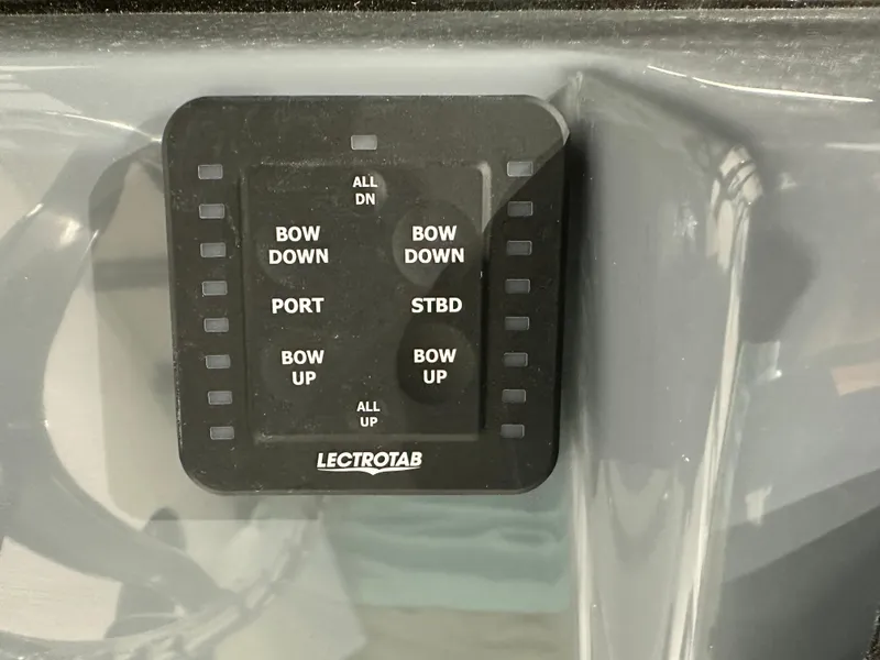 Slide: The Image of Control panel of 2025 Tidewater 220LXF boat with Lectrotab trim tab switches. - 19