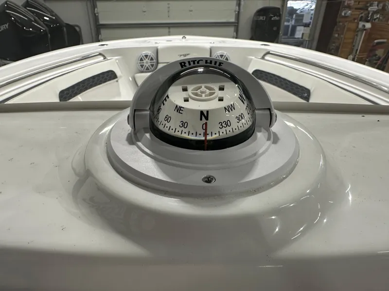 Slide: The Image of Compass on 2025 Tidewater 220LXF boat dashboard in a garage setting. - 20