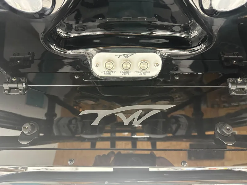 Slide: The Image of 2025 Tidewater 220LXF boat dashboard with light controls and logo. - 23