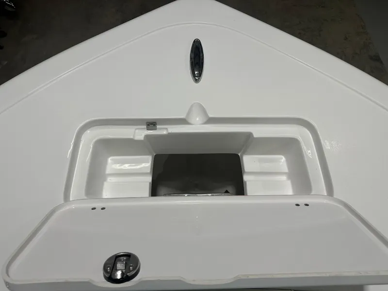 Slide: The Image of 2025 Tidewater 220LXF boat storage compartment, open lid, white interior. - 27