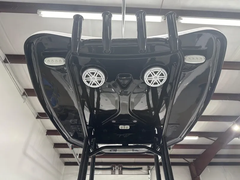 Slide: The Image of 2025 Tidewater 220LXF boat underside view with speakers and lights in a garage. - 32