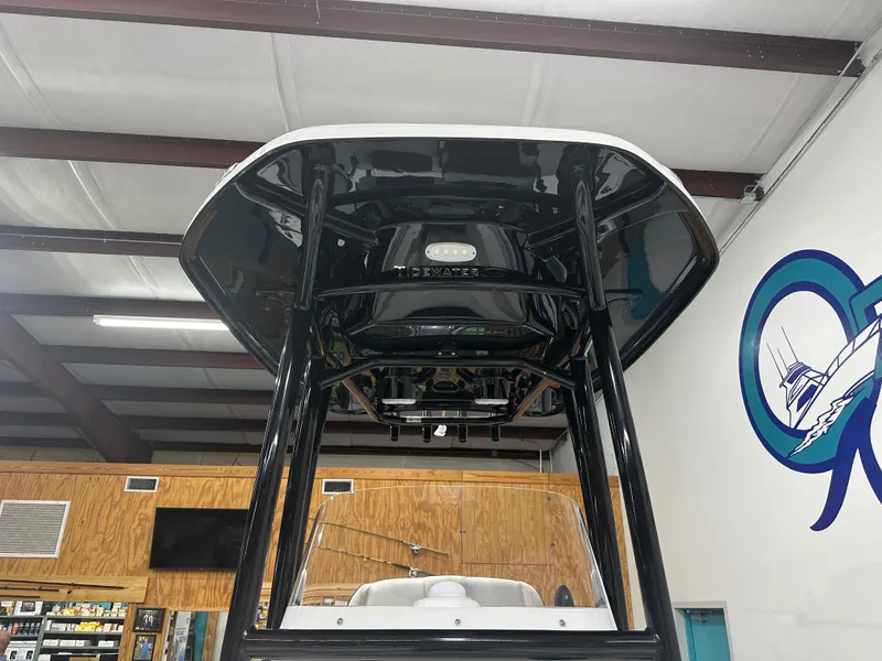 Slide: The Image of 2025 Tidewater 220LXF boat interior with T-top in showroom. - 33