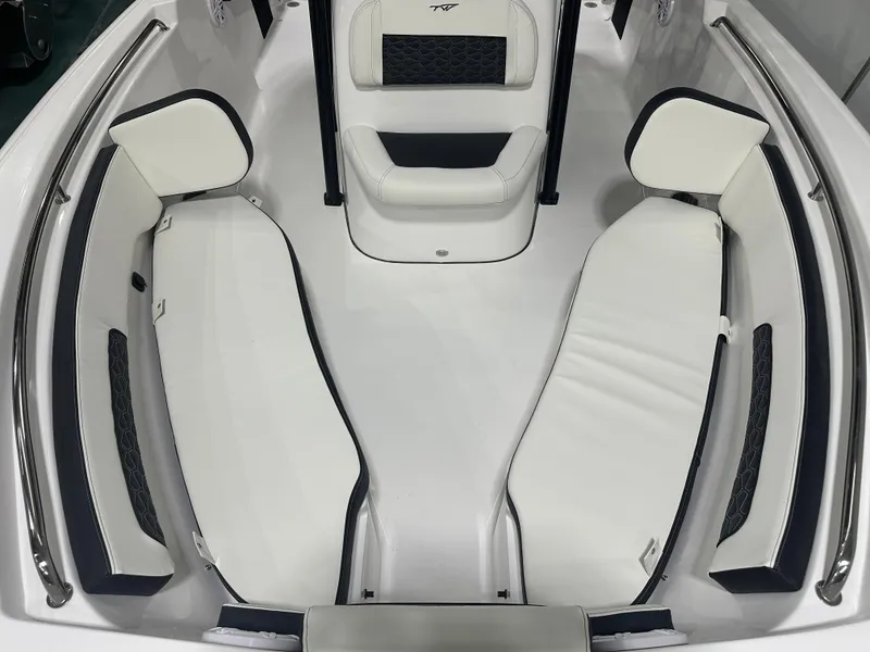 Slide: The Image of 2025 Tidewater 220LXF boat interior with white cushioned seating and sleek design. - 35