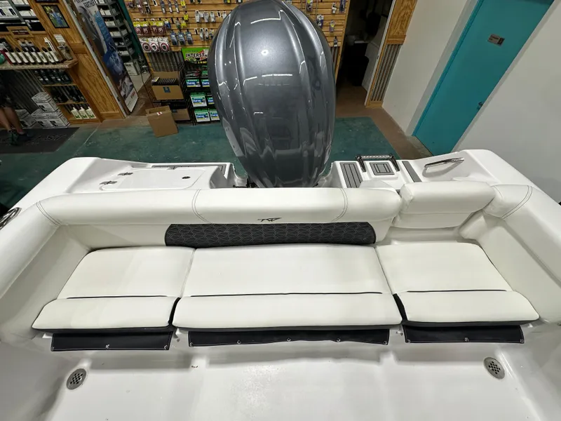 Slide: The Image of 2025 Tidewater 220LXF boat interior with white seating and outboard motor. - 37
