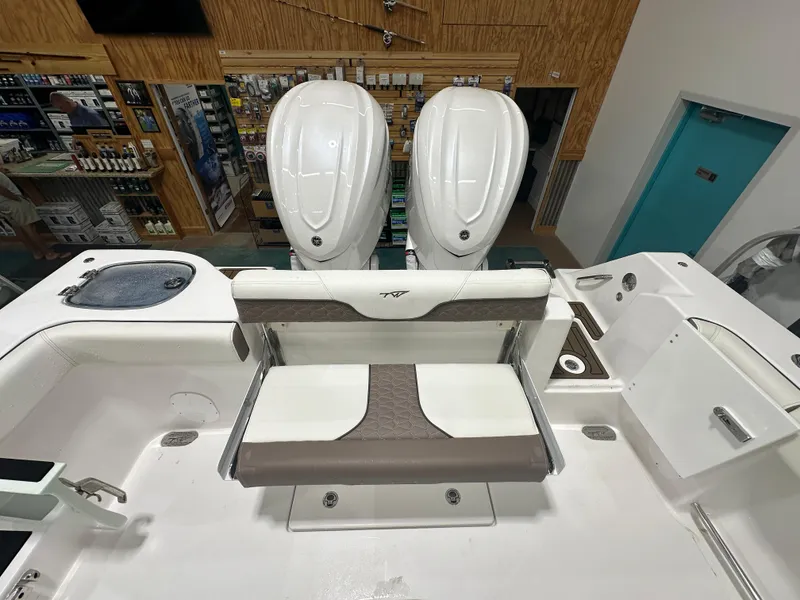Slide: The Image of 2025 Tidewater 320cc boat interior with dual engines and seating area. - 14