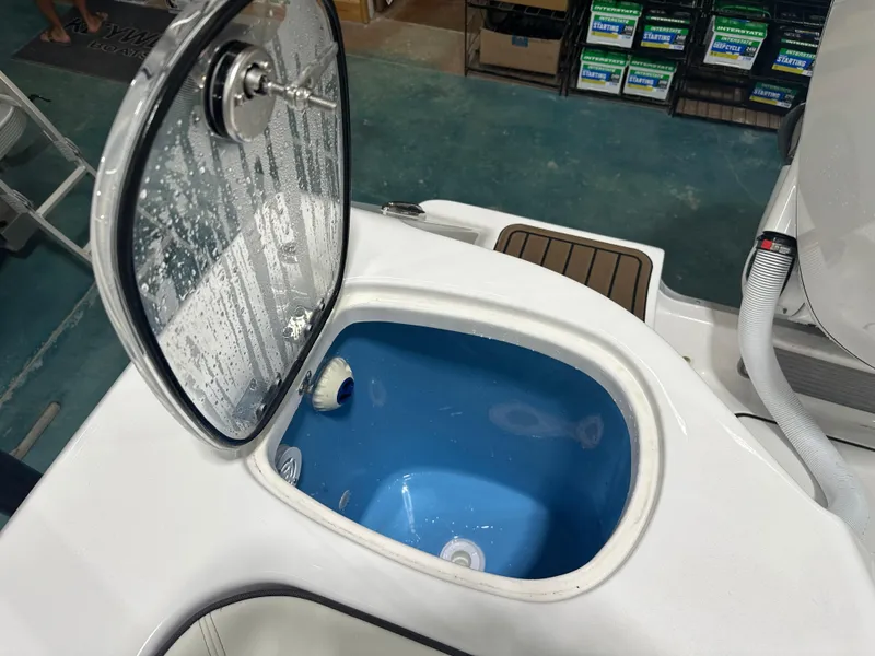 Slide: The Image of Open hatch on 2025 Tidewater 320cc boat, revealing interior compartment. - 15