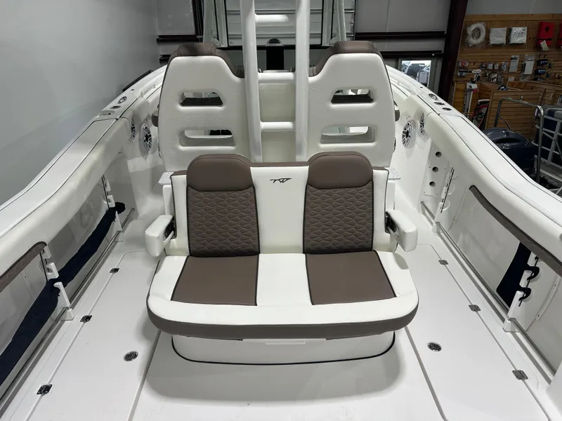 Slide: The Image of 2025 Tidewater 320cc boat interior with cushioned seating and modern design. - 17