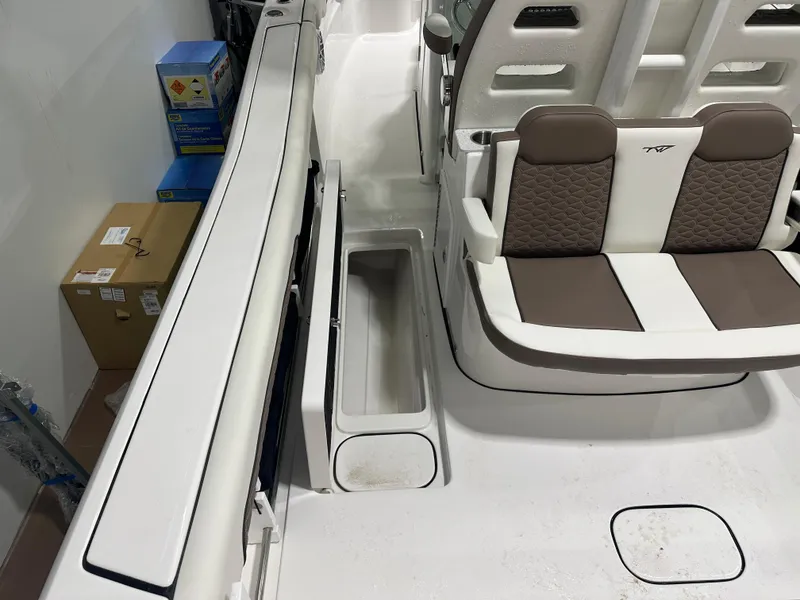 Slide: The Image of 2025 Tidewater 320cc boat interior with cushioned seating and storage compartments. - 19