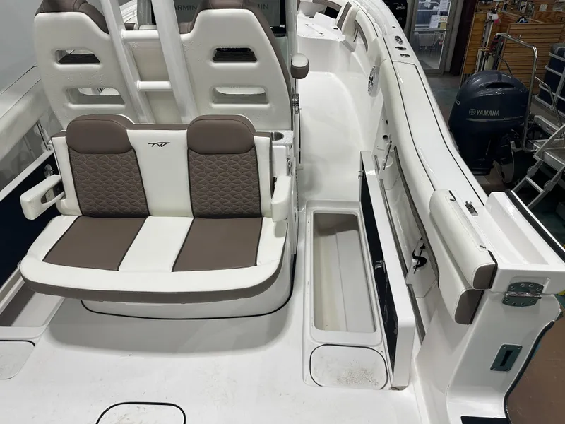 Slide: The Image of 2025 Tidewater 320cc boat interior with cushioned seating and storage compartments. - 20