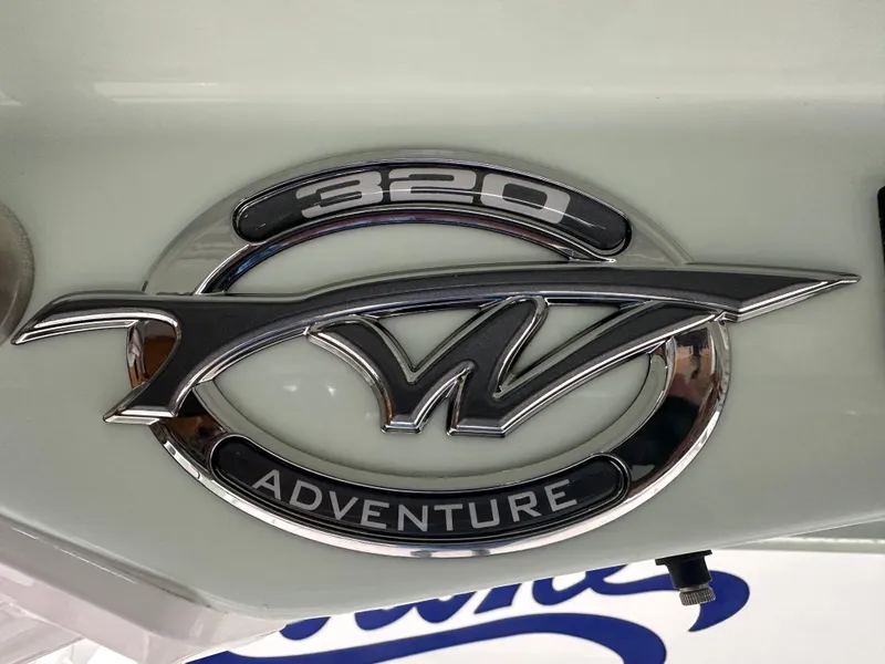 Slide: The Image of 2025 Tidewater 320cc Adventure logo on boat exterior. - 26