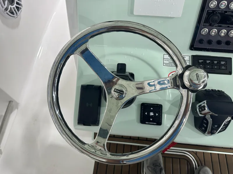 Slide: The Image of Steering wheel and controls of 2025 Tidewater 320cc boat cockpit. - 32