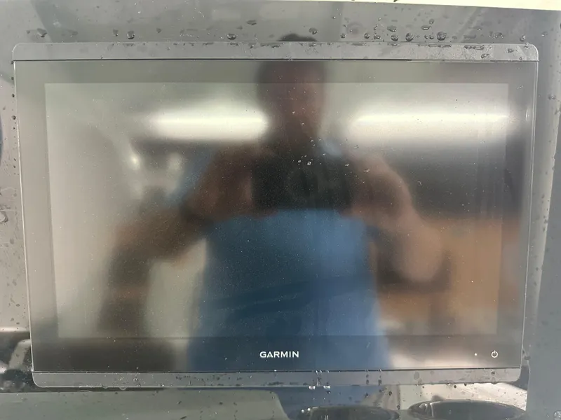 Slide: The Image of Garmin display on 2025 Tidewater 320cc boat, reflecting surroundings. - 35