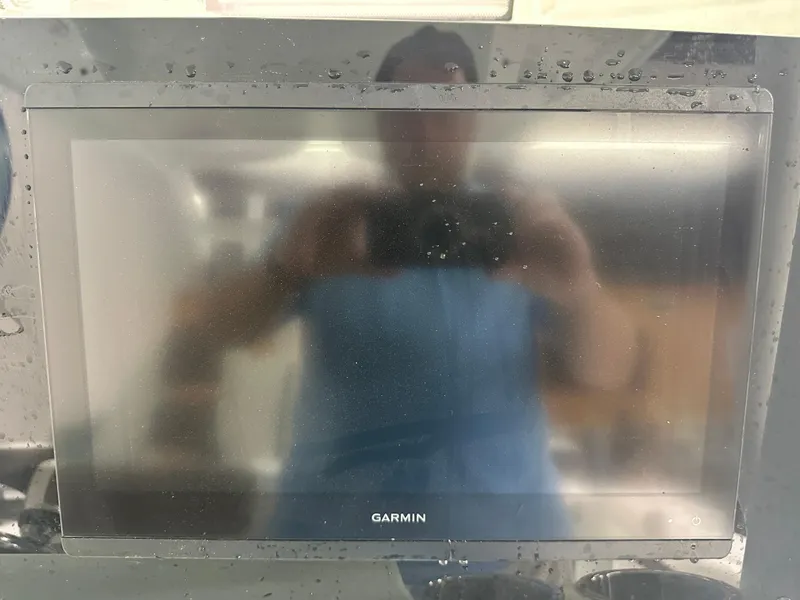 Slide: The Image of Garmin display on 2025 Tidewater 320cc boat, showing water droplets and reflection. - 36