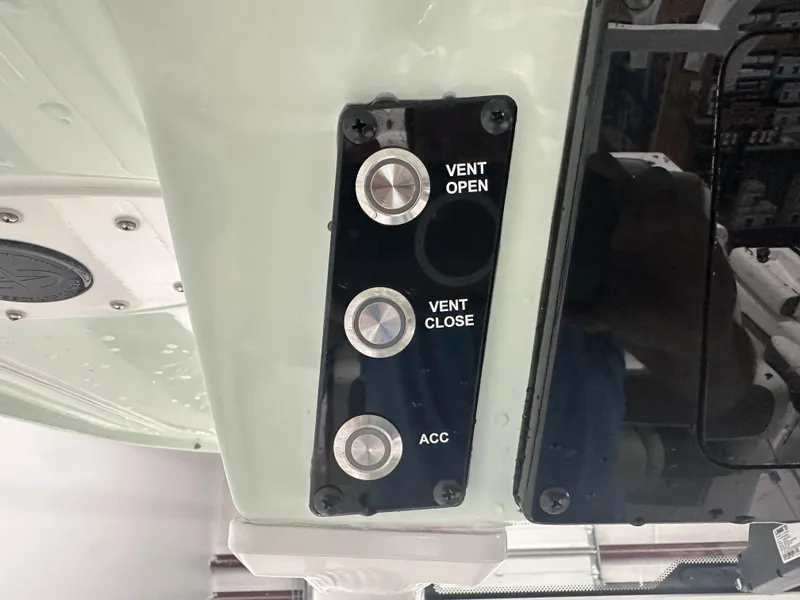 Slide: The Image of Control panel with buttons for vent open, vent close, and accessory on a 2025 Tidewater 320cc. - 40
