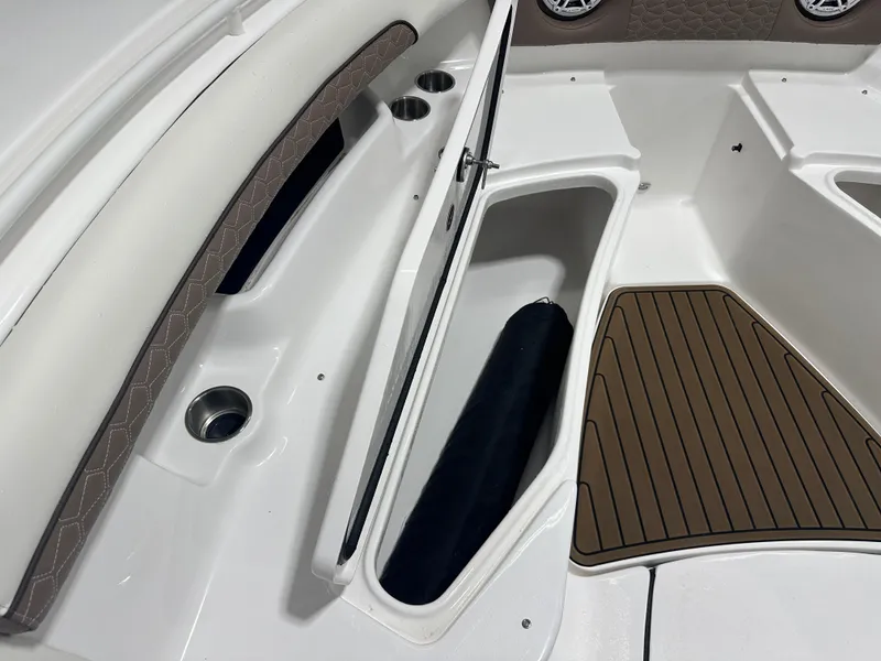 Slide: The Image of 2025 Tidewater 320cc boat interior with storage compartment and cushioned seating. - 43