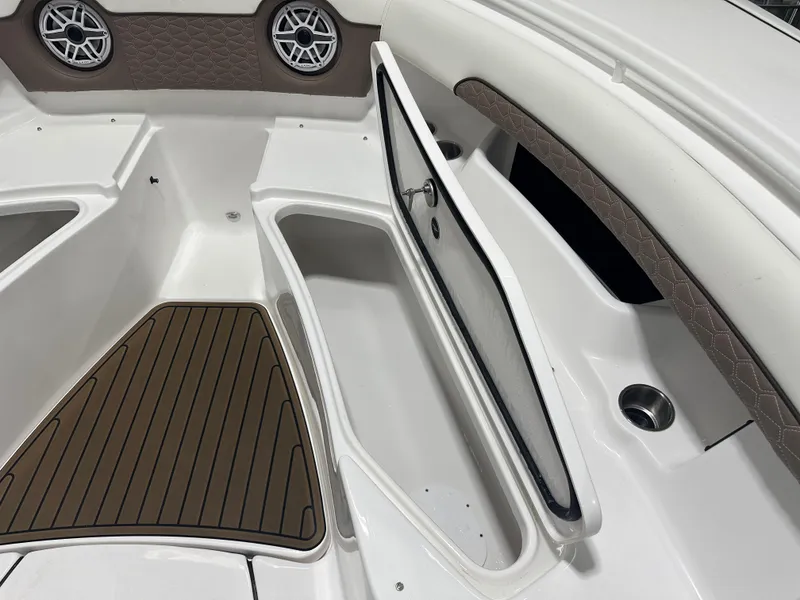 Slide: The Image of 2025 Tidewater 320cc boat interior with open storage compartment and stylish seating. - 44