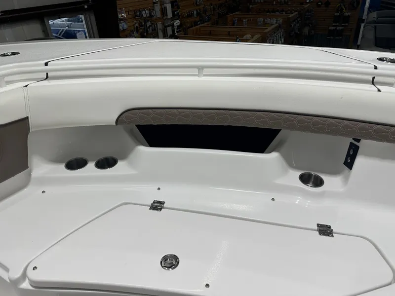 Slide: The Image of 2025 Tidewater 320cc boat interior with cup holders and storage compartment. - 45