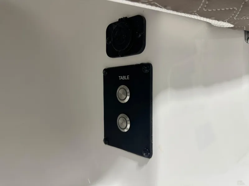 Slide: The Image of Control panel with buttons labeled "Table" on 2025 Tidewater 320cc boat. - 46