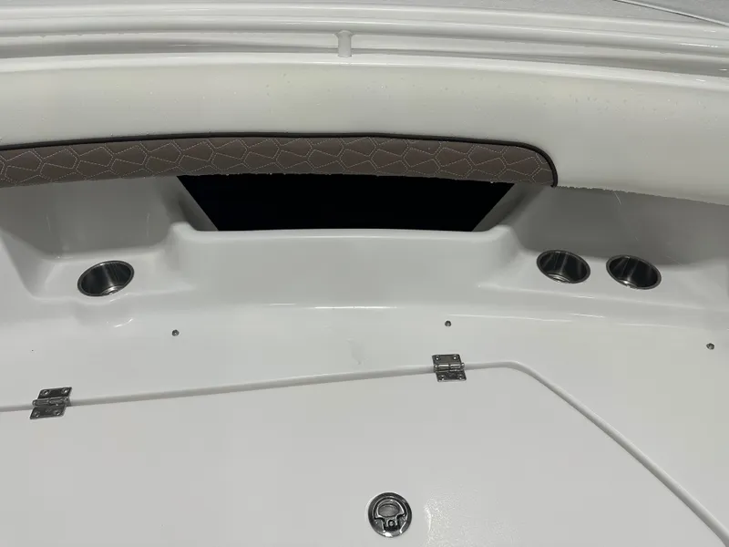 Slide: The Image of 2025 Tidewater 320cc boat interior with cup holders and cushioned seating. - 47