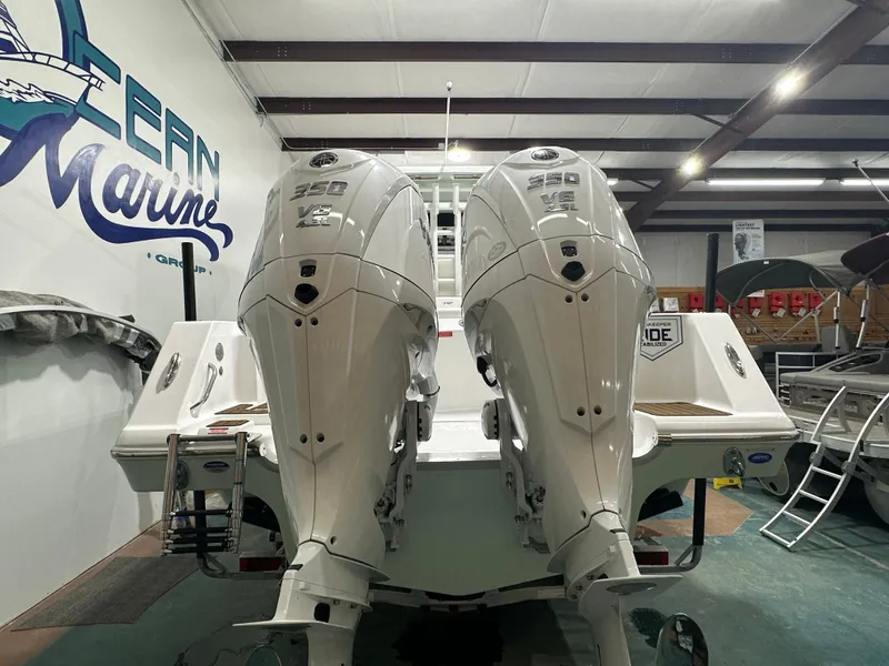 Slide: The Image of 2025 Tidewater 320cc boat with twin 350 V8 engines in a showroom. - 7