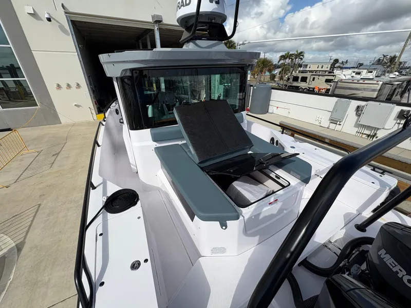 Slide: The Image of 2023 Axopar 28 AFT CABIN boat with sleek design and modern features, docked outdoors. - 10