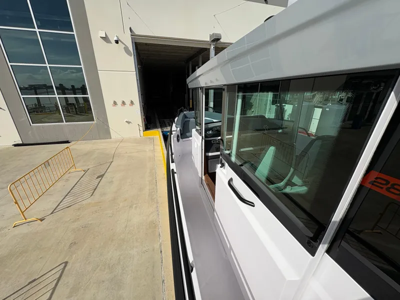 Slide: The Image of 2023 Axopar 28 AFT CABIN boat docked near a building. - 11