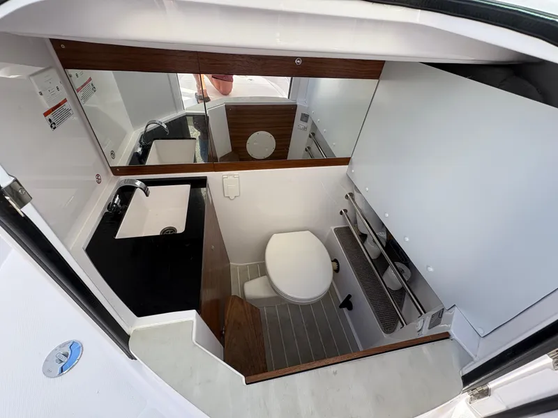 Slide: The Image of 2023 Axopar 28 AFT CABIN bathroom with modern fixtures and sleek design. - 16