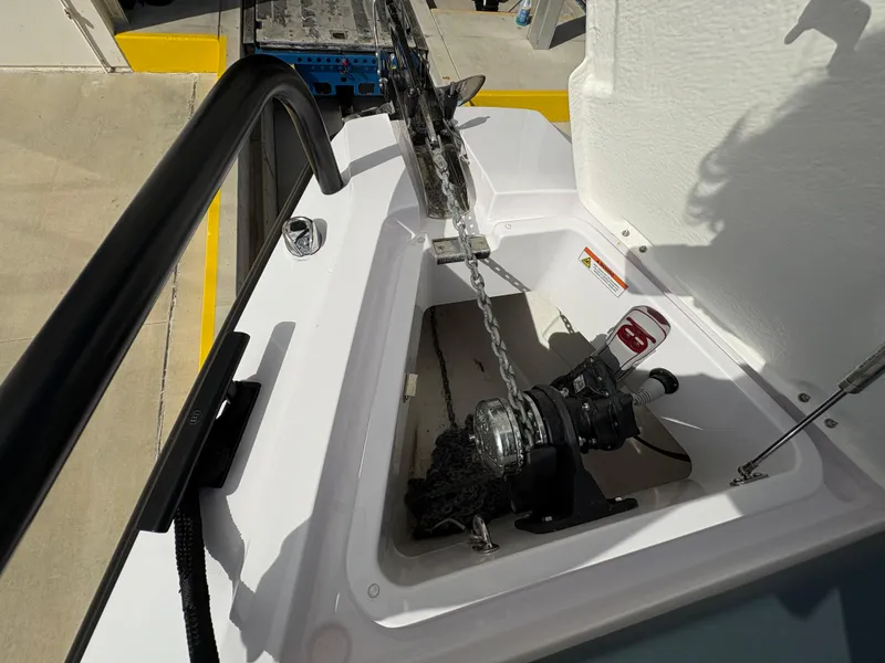 Slide: The Image of Anchor compartment of 2023 Axopar 28 AFT CABIN boat, featuring a winch system. - 18