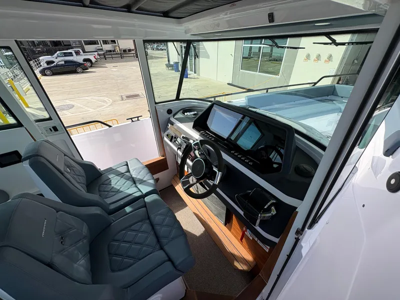 Slide: The Image of 2023 Axopar 28 AFT CABIN interior with modern dashboard and seating. - 21