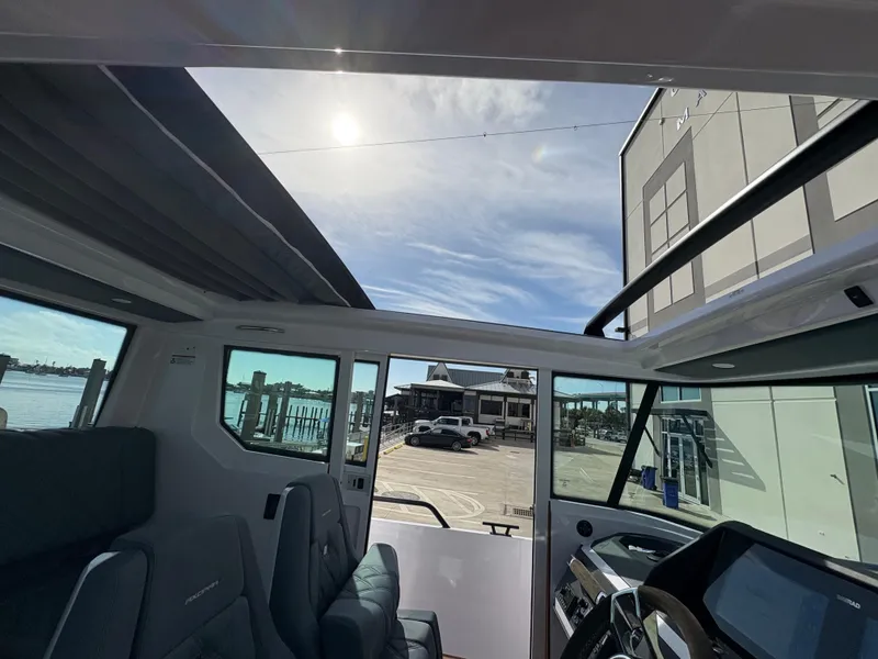 Slide: The Image of Interior view of 2023 Axopar 28 AFT CABIN boat with waterfront background. - 29