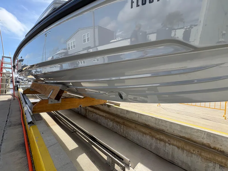 Slide: The Image of 2023 Axopar 28 AFT CABIN boat on dry dock, side view. - 5