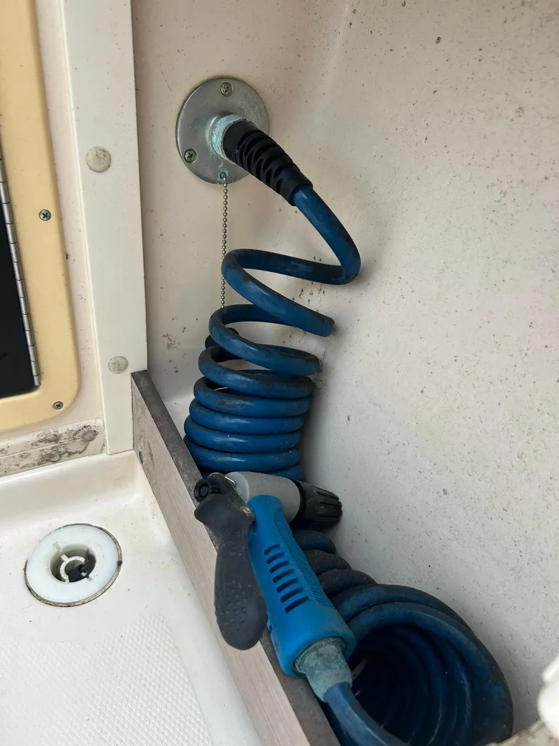 Slide: The Image of Coiled blue hose in 1997 Grady-White 232 Gulfstream boat. - 11