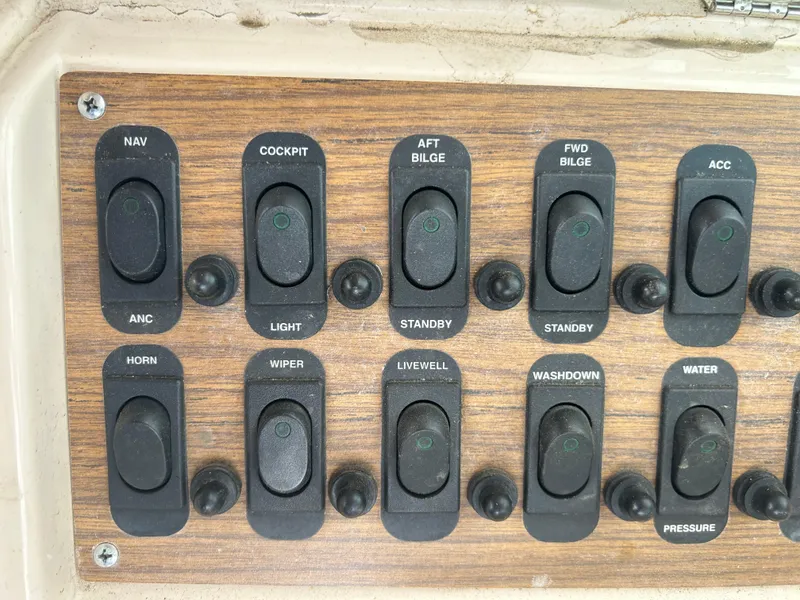 Slide: The Image of Control panel of a 1997 Grady-White 232 Gulfstream boat with labeled switches. - 17