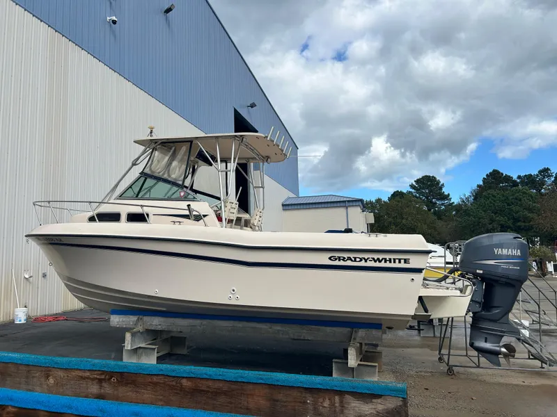 Slide: The Image of 1997 Grady-White 232 Gulfstream boat with Yamaha outboard, docked outdoors. - 2