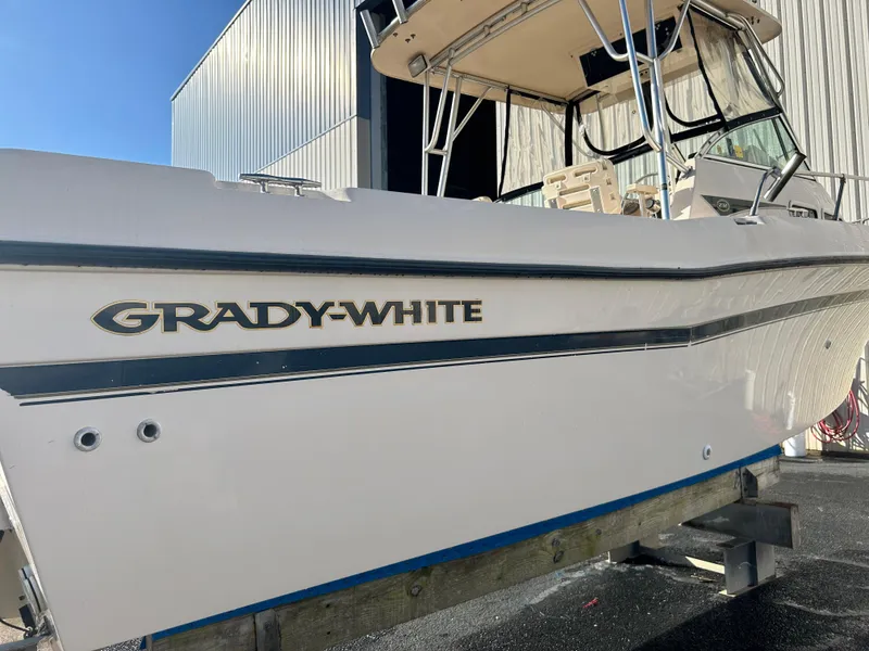 Slide: The Image of 1997 Grady-White 232 Gulfstream boat, white hull, docked outdoors. - 4