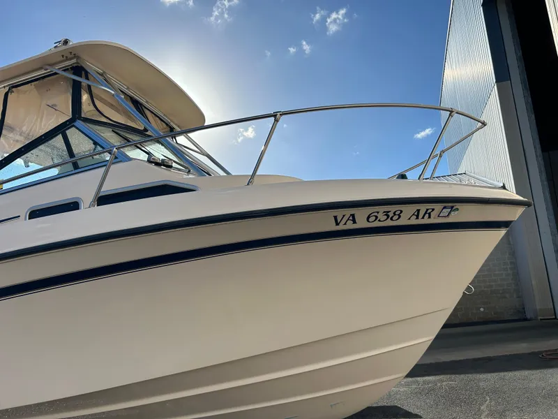 Slide: The Image of 1997 Grady-White 232 Gulfstream boat with registration VA 638 AR, docked under a sunny sky. - 5