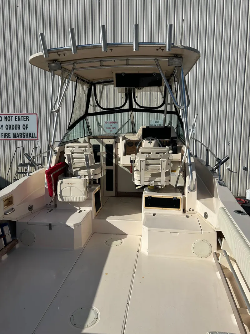 Slide: The Image of 1997 Grady-White 232 Gulfstream boat with dual seats and fishing rod holders. - 7