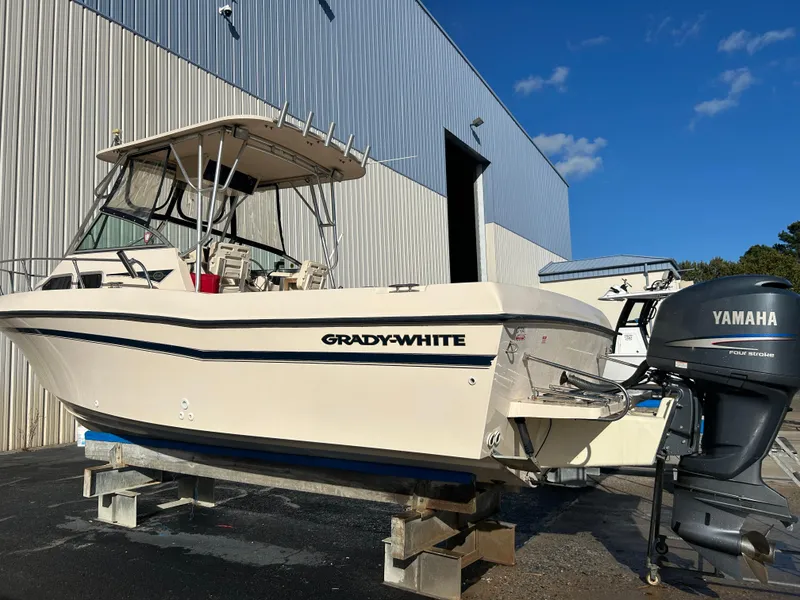 Slide: The Image of 1997 Grady-White 232 Gulfstream boat with Yamaha outboard motor, docked outdoors. - 9