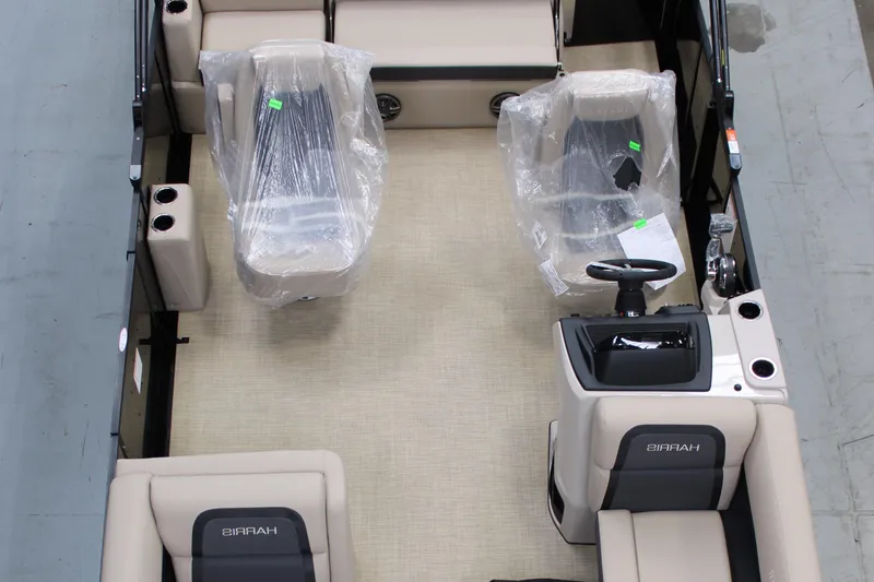 Slide: The Image of 2025 Harris Cruiser 210 interior with wrapped seats and steering console. - 1