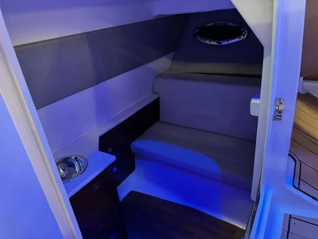Slide: The Image of Interior cabin of 2025 Chaparral 280 OSX boat with seating and sink. - 10