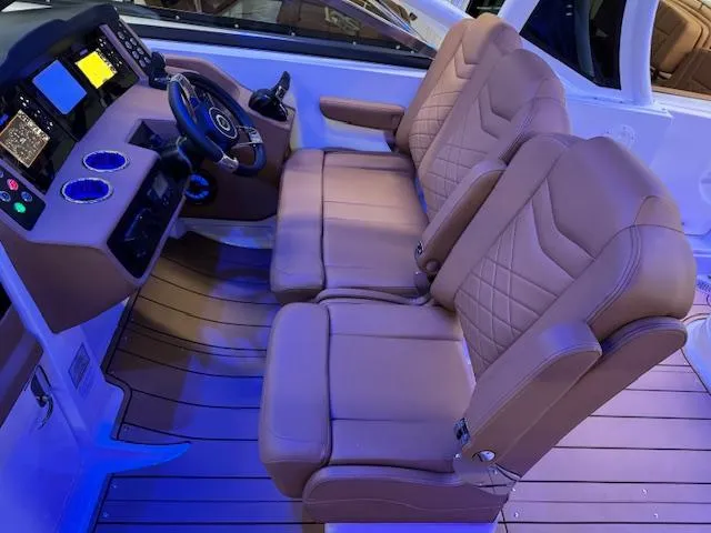 Slide: The Image of 2025 Chaparral 280 OSX boat interior with luxurious seating and modern dashboard. - 11