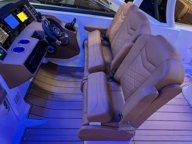 Slide: The Image of 2025 Chaparral 280 OSX boat interior with luxurious seating and modern dashboard. - 12