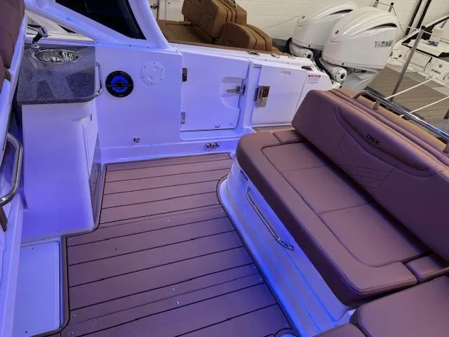 Slide: The Image of 2025 Chaparral 280 OSX boat interior with plush seating and modern design. - 17